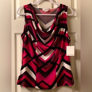 Red, white, pink, purple, maroon and black woman’s blouse. Never worn. Tags on.